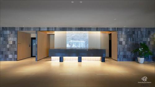 a lobby with a bench in the middle of a building at Daiwa Roynet Hotel Kagoshima Tenmonkan PREMIER - former Daiwa Roynet Hotel Kagoshima Tenmonkan in Kagoshima