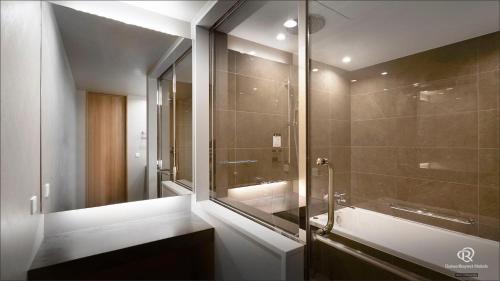 a bathroom with a glass shower and a sink at Daiwa Roynet Hotel Kagoshima Tenmonkan PREMIER - former Daiwa Roynet Hotel Kagoshima Tenmonkan in Kagoshima