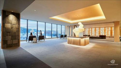 a lobby with a sculpture on a table in a building at Daiwa Roynet Hotel Kagoshima Tenmonkan PREMIER - former Daiwa Roynet Hotel Kagoshima Tenmonkan in Kagoshima