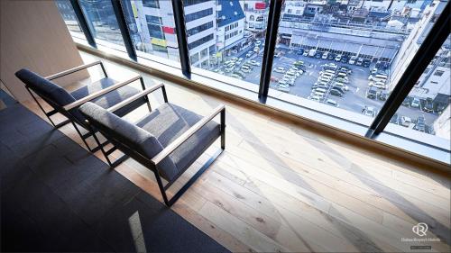 a bench sitting in front of a large window at Daiwa Roynet Hotel Kagoshima Tenmonkan PREMIER - former Daiwa Roynet Hotel Kagoshima Tenmonkan in Kagoshima