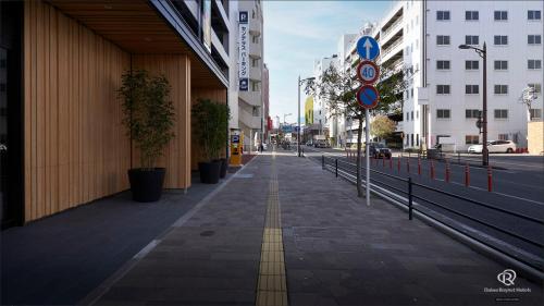 an empty sidewalk in a city with buildings at Daiwa Roynet Hotel Kagoshima Tenmonkan PREMIER - former Daiwa Roynet Hotel Kagoshima Tenmonkan in Kagoshima