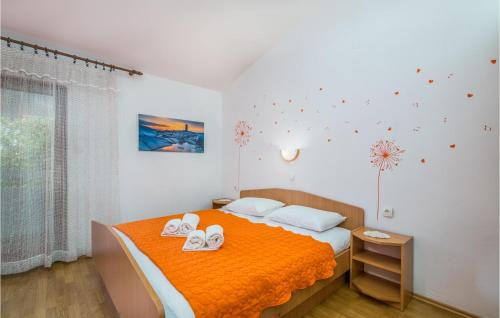 a bedroom with a bed with two towels on it at Nice Apartment In Bascanska Draga With Wifi in Draga Bašćanska