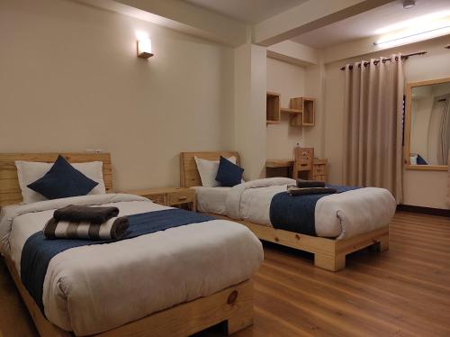 a hotel room with two beds in a room at Awale House in Pātan