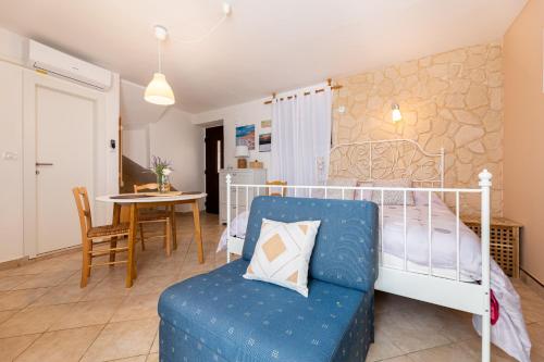a bedroom with a bed and a table and a chair at Apartments Riva in Baška