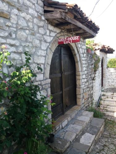 an entrance to a stone building with a wooden door at Guest House Luli in Berat