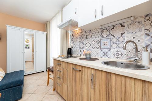 a kitchen with a sink and a counter at Apartments Riva in Baška
