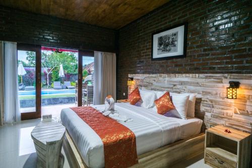 Un pat sau paturi într-o cameră la Kubu Nyang Nyang Uluwatu