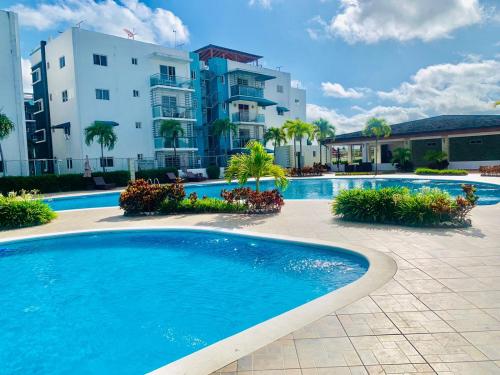 a large swimming pool in front of a building at Chez Coralie in Santiago de los Caballeros