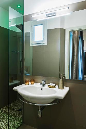 a bathroom with a white sink and a mirror at Hotel Des Bains in Cattolica