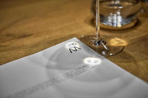 a paper with a smiley face drawn on it next to a glass at Milka Boutique Hotel in Kranjska Gora