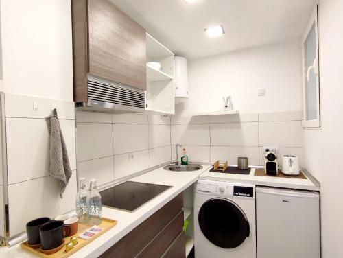 a small kitchen with a sink and a dishwasher at Las Canteras Suite in Las Palmas de Gran Canaria