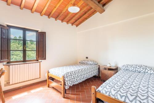a bedroom with two beds and a window at La Casina di Elisa in Montecarlo
