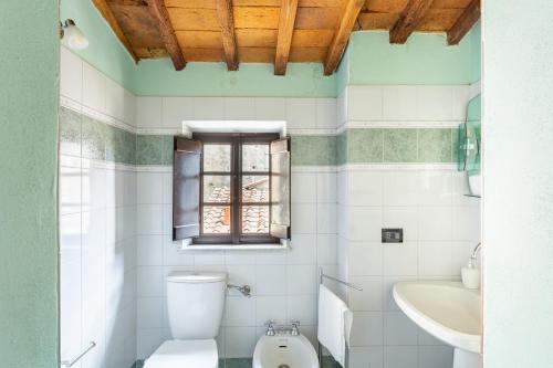 a bathroom with a toilet and a sink at La Casina di Elisa in Montecarlo