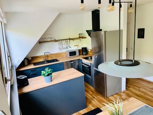 a kitchen with blue cabinets and a counter top at Zur Rotbuche in Zeltingen-Rachtig