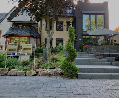 a building with stairs and a sign in front of it at Zur Rotbuche in Zeltingen-Rachtig