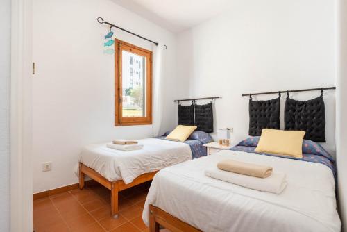 En eller flere senge i et værelse på Apartamento La Brisa