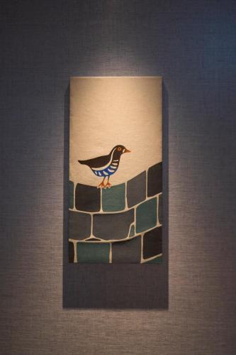 a picture of a bird on top of a wall at Hotel Resol Trinity Naha in Naha