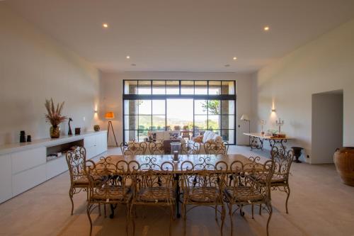 a kitchen and dining room with a table and chairs at Le Mas Saint Michel Grimaud in Grimaud