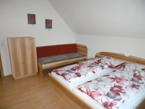 a bedroom with a bed and a bench in it at Gausrab in Hinterstoder