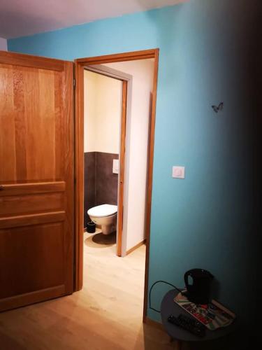 an open door to a bathroom with a toilet at chambre d'hôtes nos racines (chez Muriel et Philippe) in Saulxures-sur-Moselotte