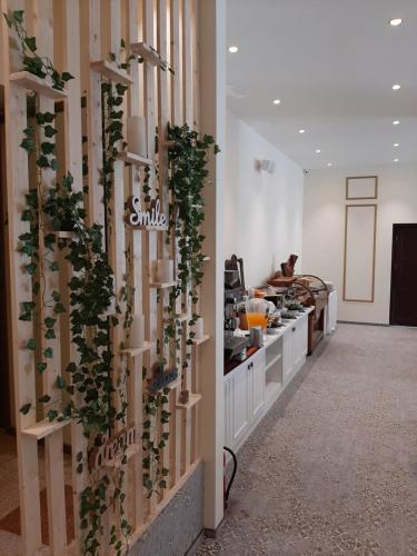 a kitchen with a wall with plants on it at Hotel Astoria City Center in Iaşi