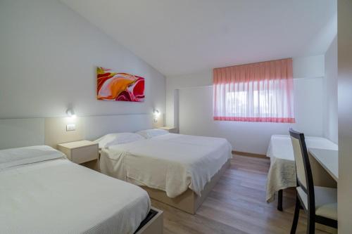 Ένα ή περισσότερα κρεβάτια σε δωμάτιο στο Hotel Bellavista