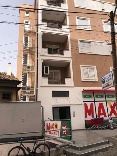 a bike parked in front of a building at Diti's Apartment in Shkodër
