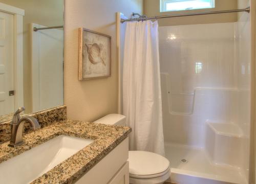 a bathroom with a sink and a toilet and a shower at Ocean Adventure in Ocean Shores