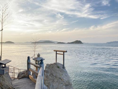 a dock with a view of the water at Seaside Villa SASAO in Aji