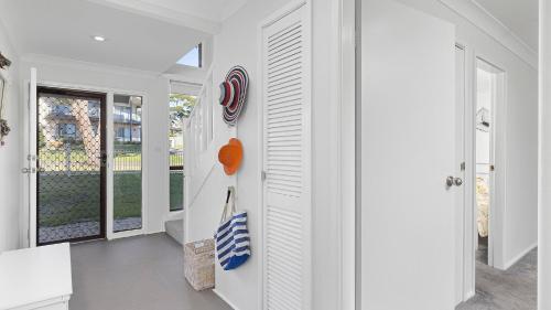a hallway with white walls and a door to a porch at Diggers Drive No11 in Lemon Tree Passage