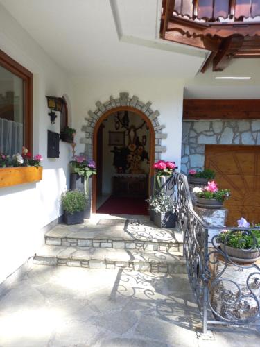 a entrance to a building with a gate and flowers at Landhaus Wieser in Ramsau am Dachstein