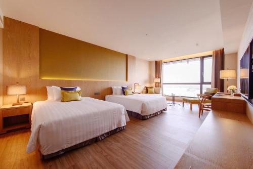 a hotel room with two beds and a large window at Golden Lake Hotel in Jinhu