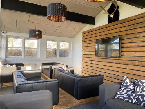 a living room with two couches and a tv at Camp Hverringe in Dalby