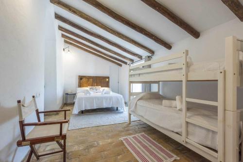 a bedroom with a bunk bed and a desk at Hacienda San Antonio in Marchena