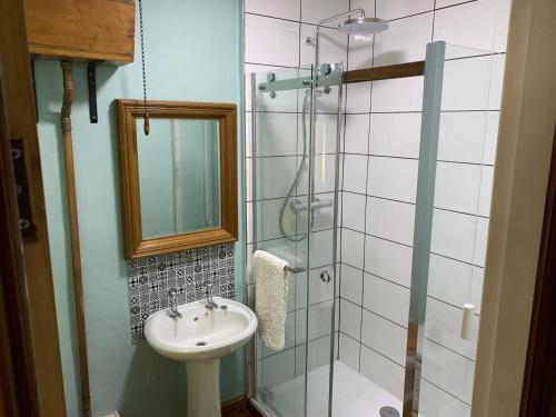 a bathroom with a sink and a glass shower at Meg's Den in Hebden Bridge