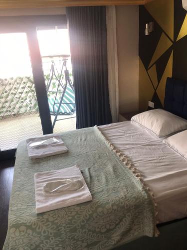 a bedroom with a bed with two napkins on it at Middle Village in Istanbul