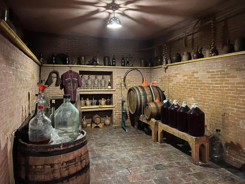 a room with bottles and barrels and a brick wall at Georgian House in Tbilisi City