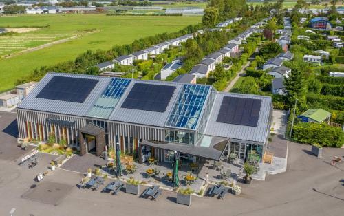 an overhead view of a building with solar panels on it at Vakantiepark Koningshof in Rijnsburg