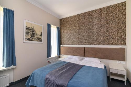 a bedroom with a bed and a brick wall at Voyage in Odesa