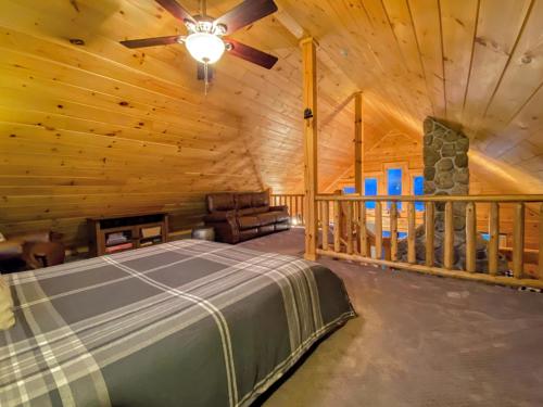 a bedroom in a log cabin with a bed and a fireplace at Cozy modern log cabin in the White Mountains - AC - granite - less than 10 minutes from Bretton Woods in Carroll