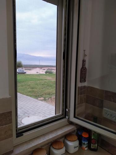 a window with a view of a field at Dead sea families unit in Ovnat