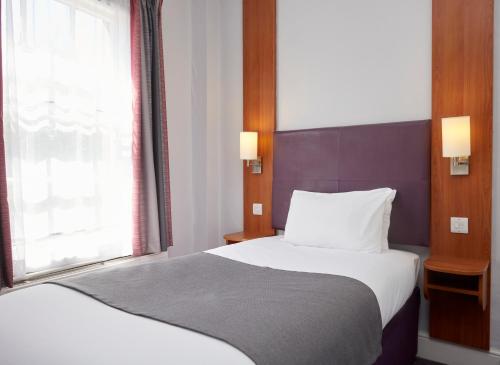 a bedroom with a large bed and a window at Wheatsheaf by Chef & Brewer Collection in North Waltham