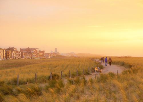 a group of people walking down a path in a field at Vakantiepark Koningshof in Rijnsburg