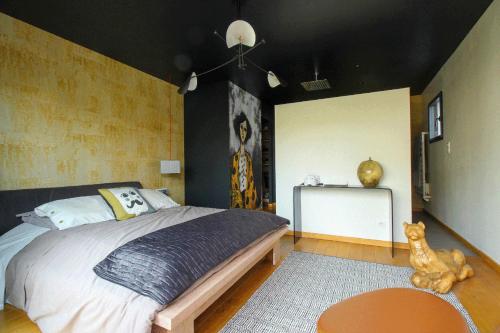 a bedroom with a large bed and a table at La Villa des Temps Modernes in Albi