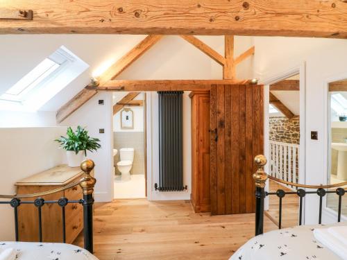 a bedroom with a bed and a vaulted ceiling at Lake View in Crediton