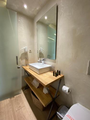 a bathroom with a sink and a mirror at Panellinion Luxury Rooms in Kalamata