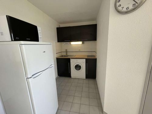 une cuisine avec un réfrigérateur et une machine à laver dans l'établissement Deux pièces rénové avec terrasse, parking privé à Port Camargue - FR-1-250-173, à Saint-Mélany