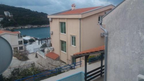 a building with a balcony with a view of the water at GRAMISI apartments in Kruče