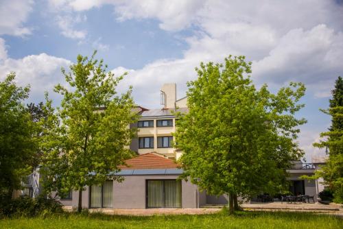 a building with trees in front of it at Hotel Prebold in Prebold