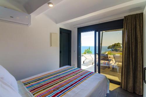 een slaapkamer met een bed en uitzicht op de oceaan bij 4 bedrooms villa at Lloret de Mar 100 m away from the beach with sea view private pool and enclosed garden in Lloret de Mar